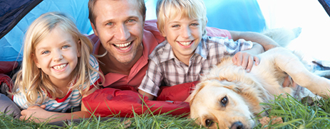 Young father poses with children in tent